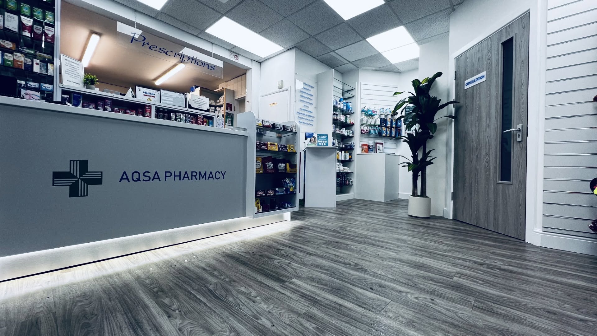 Inside Aqsa Pharmacy in High Wycombe, showing the prescription counter and consultation room